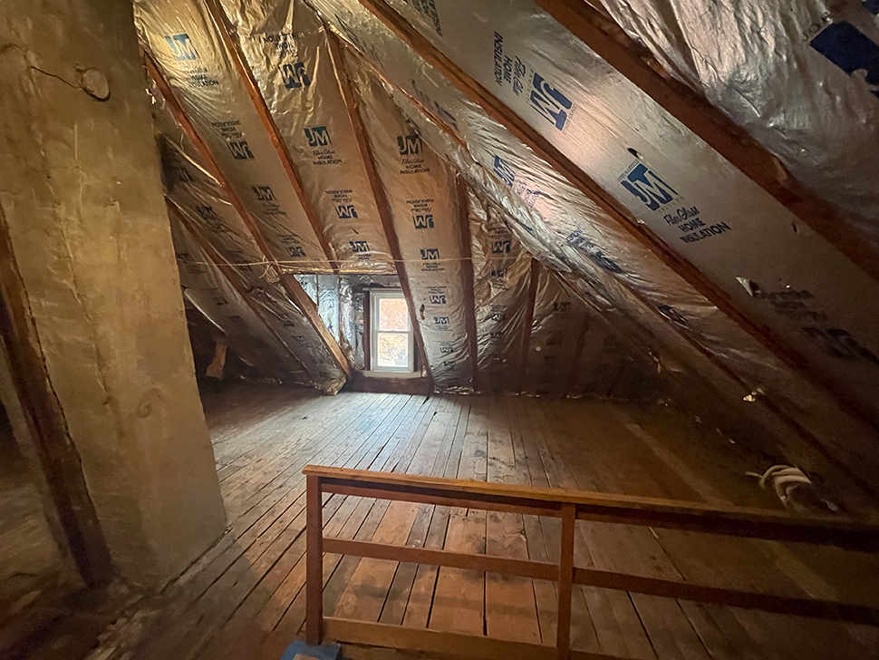 A wide-angle shot of the attic before any work began