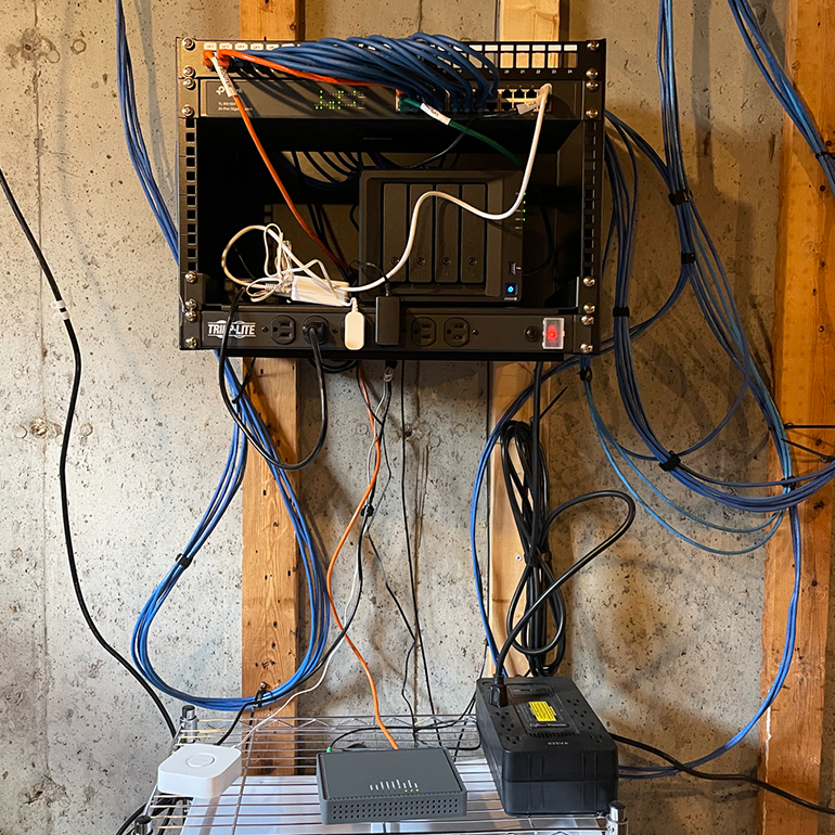 My finished network rack in all its moderately unorganized glory.